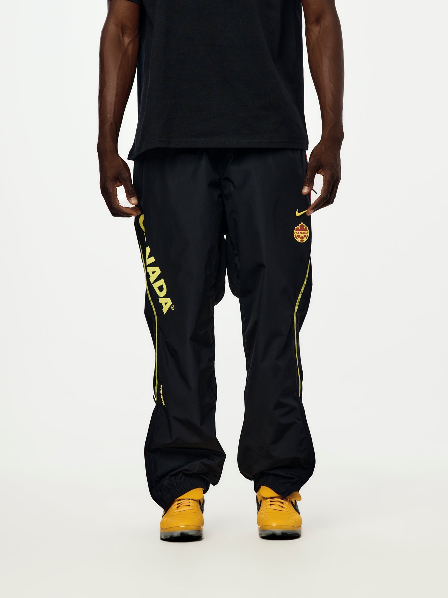 Canada x NOCTA x Nike Woven Track Pants (Black/Gym Red/Sonic Yellow/Sonic Yellow)